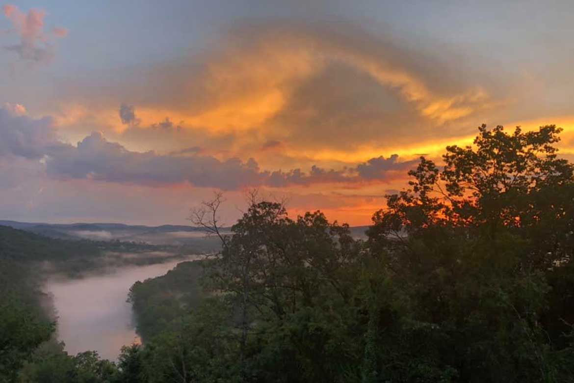 a stunning White River sunset with fog rising up from the river