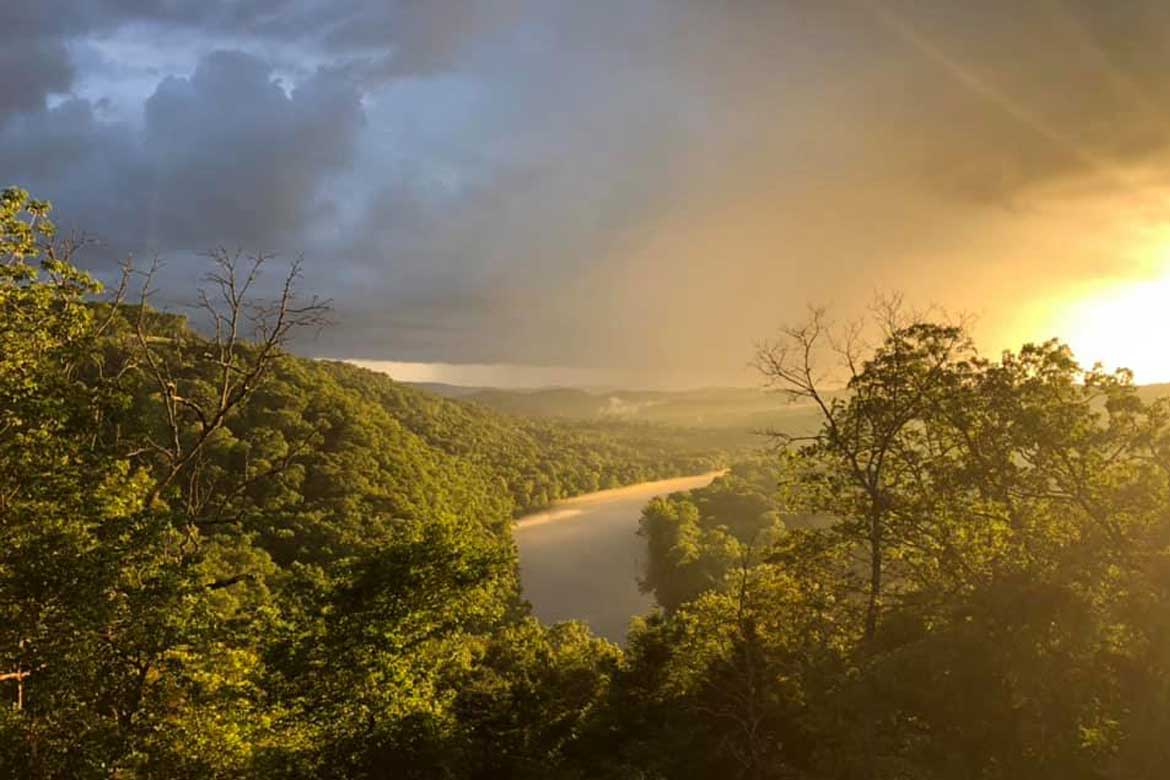 Storm clouds rolling in over the White River as it winds through the Ozark Mountains