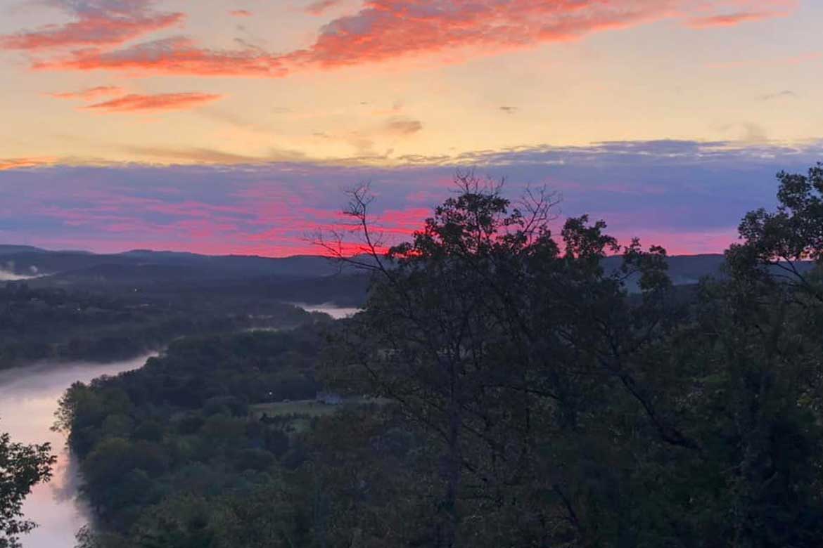 Colorful sunset over the White River and the Ozark Mountains
