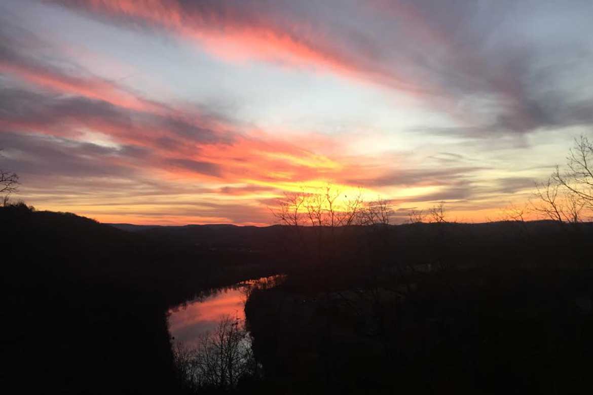 Colorful Ozark Sunset with the colors reflecting off the White River